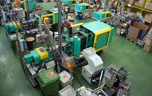 Injection molding machines in a large factory.