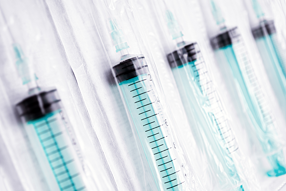 Bags of plastic syringes in a row.